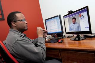 Man communicating via video on a computer