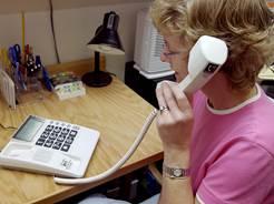Woman using a captioned telephone