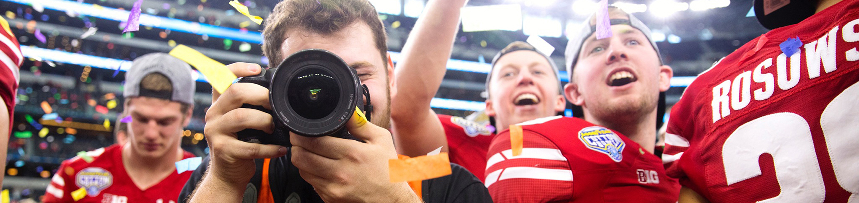 image of a camera man taking pictures at a football game