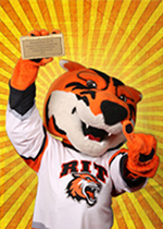 Image of Ritchie the tiger holding a golden brick award
