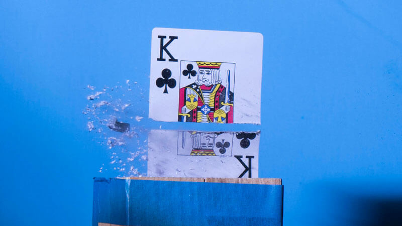 High speed photo of a playing card being split in two
