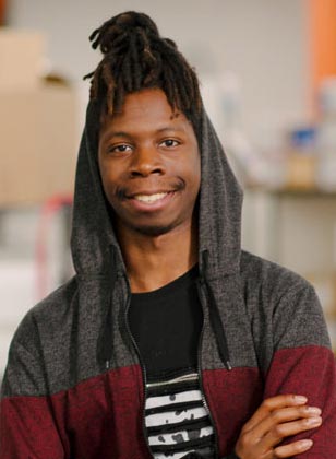 Student smiling with a hoodie on