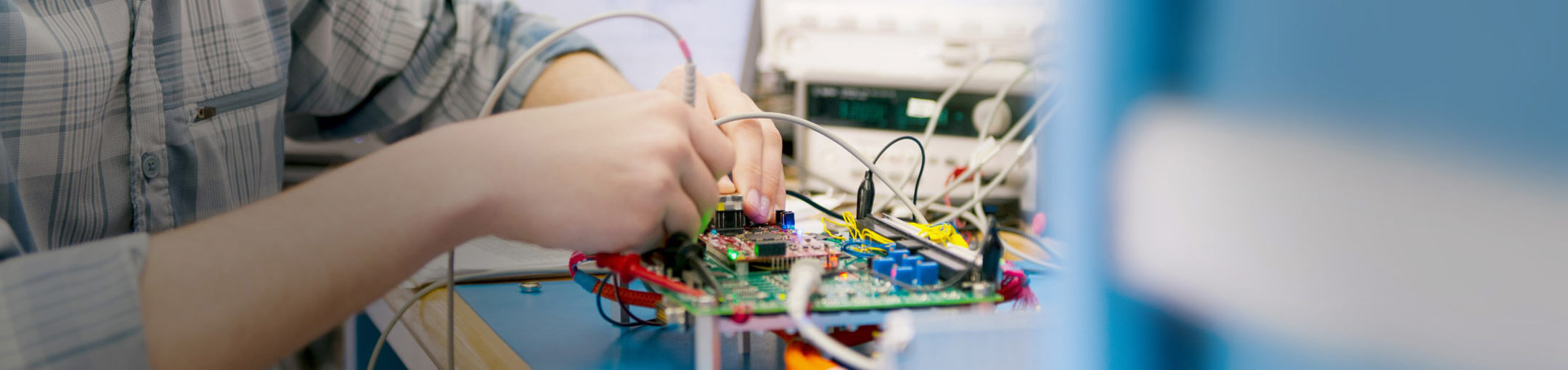 A student working on a computer motherboard.