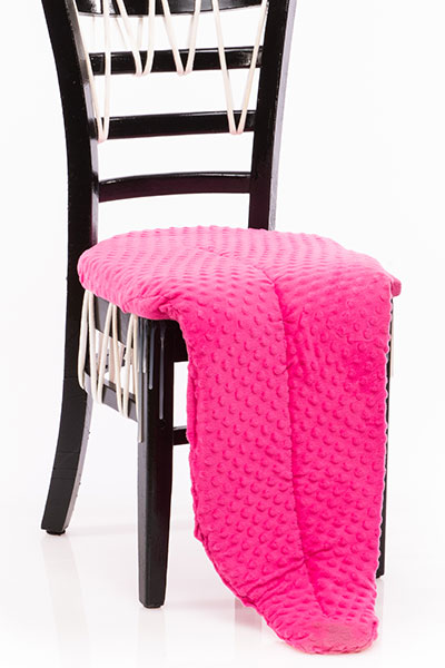 A black chair with a pink foam tongue (as the seat) and decorative white yarn teeth.