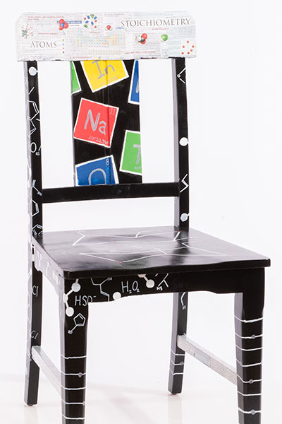 A collection of chemistry concepts on a chair