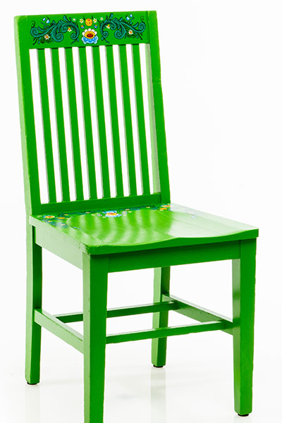 Green chair with floral pattern on upper back and seat