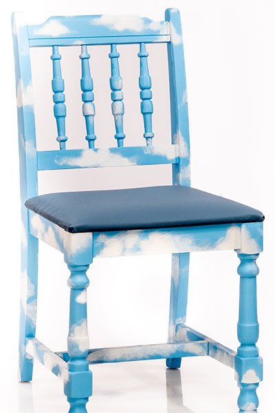 Light Sky Blue Chair with scattered white clouds painted throughout the wood of the chair. Upholstered slate blue seat cushion. 