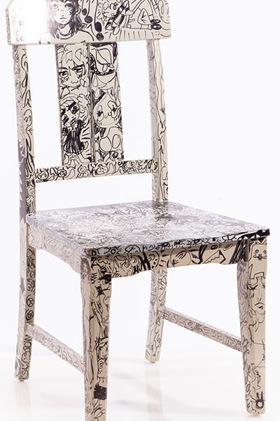This is a wooden chair I painted white and doodled all over with black marker. 