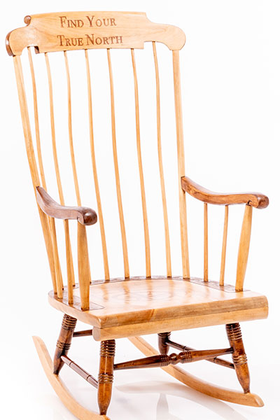 Rocking chair with compass on seat and saying "find your true north" on back