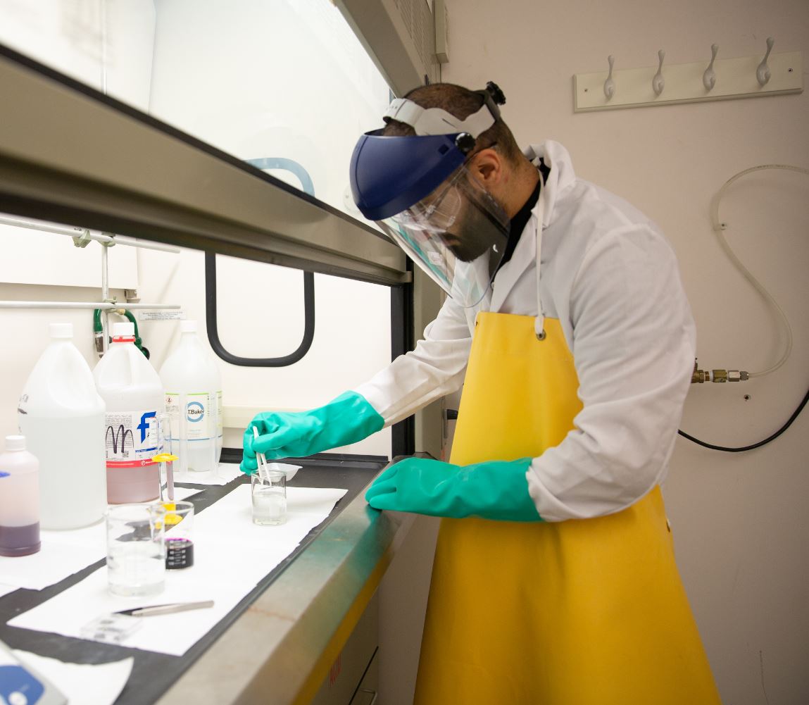 Alireza is seen here, processing samples in the fume hood.