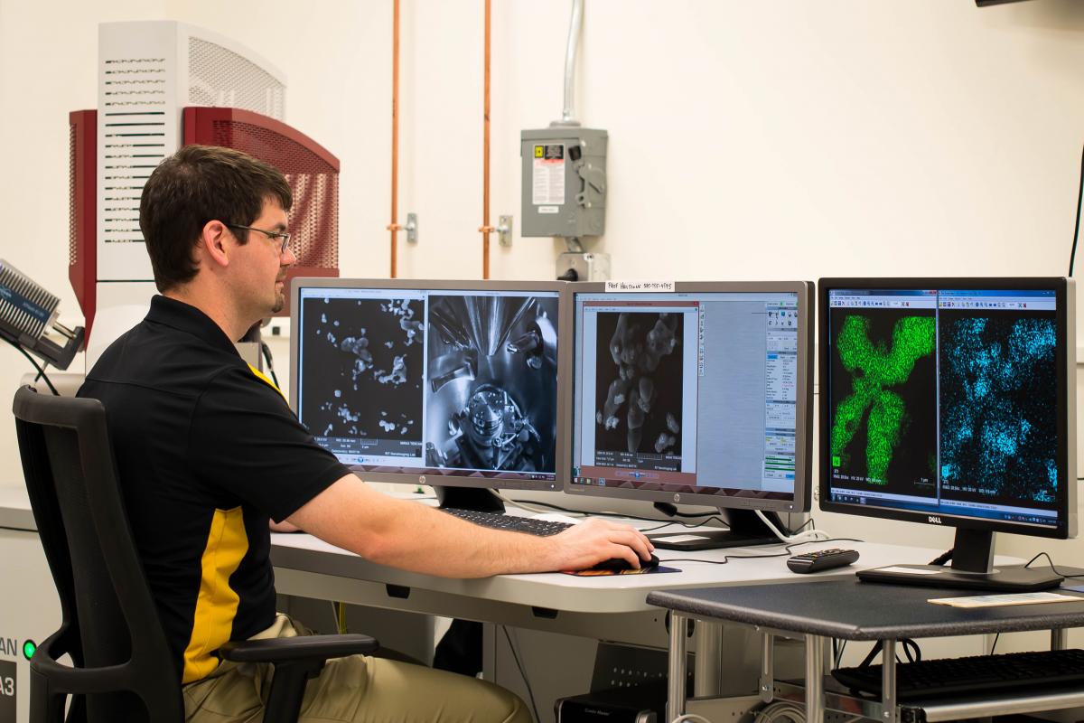 Thomas is seen here using the TESCAN MIRA3 scanning electron microscope (SEM; RIT NanoImaging Lab), where he is analyzing a sample containing Ag nanoparticles on a GaAs substrate for use in MacEtch experiments.