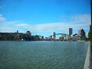 Photo of Rochester NY skyline looking over water.