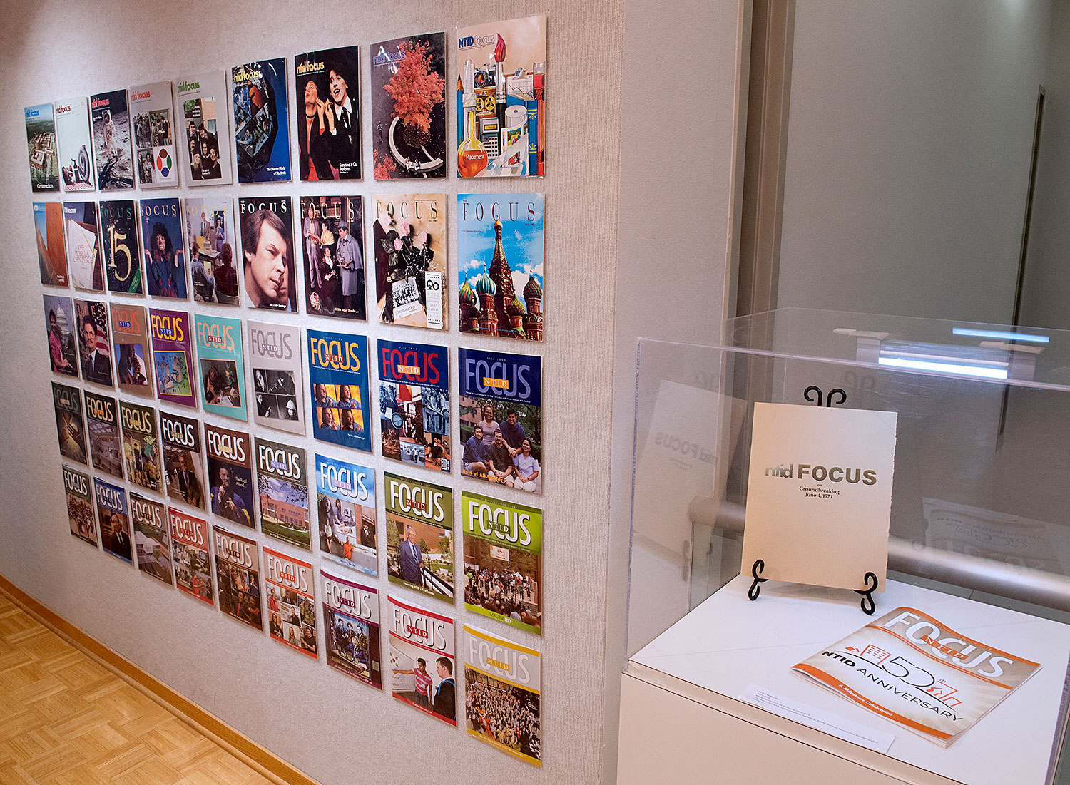 Photo of a display in NTID showcasing all fifty covers of FOCUS magazine