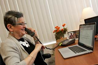 Woman using a web-captioned telephone