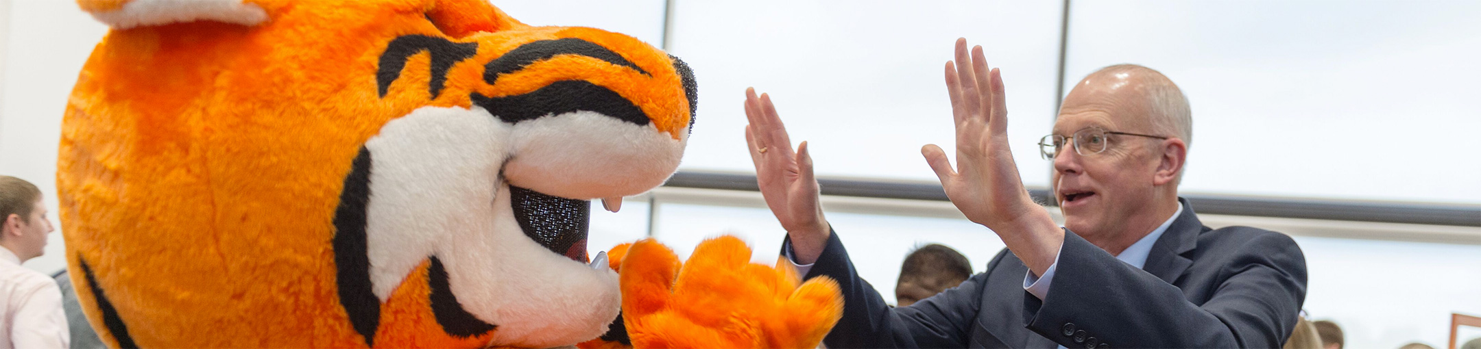 President Munson giving Ritchie the Tiger a high five