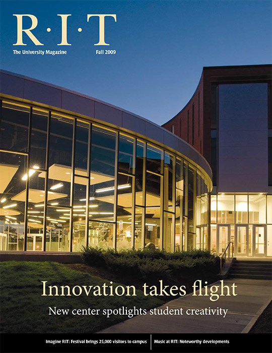 University Magazine cover featuring round glass building at night.