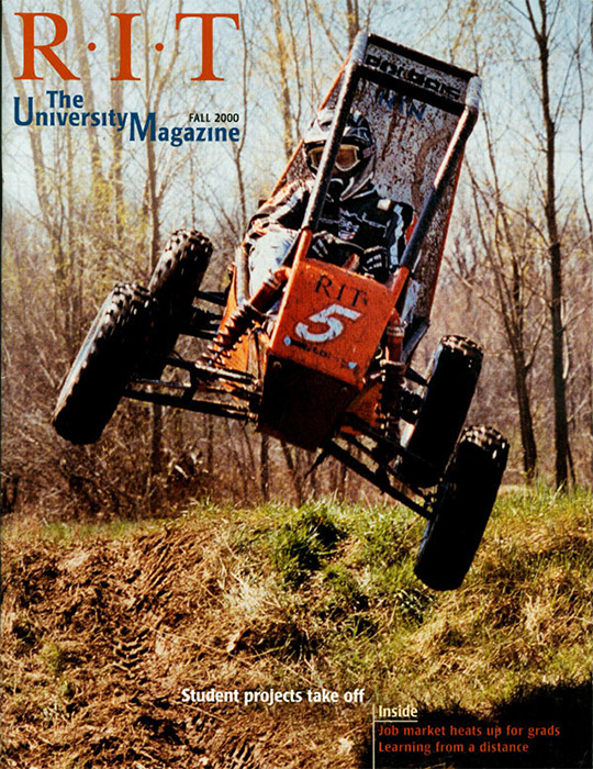 University Magazine cover featuring airborne Baja car .