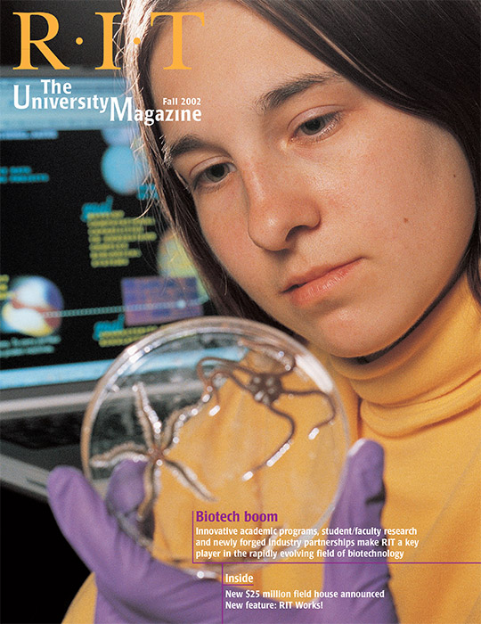 University Magazine cover featuring woman holding and looking at glass sphere.