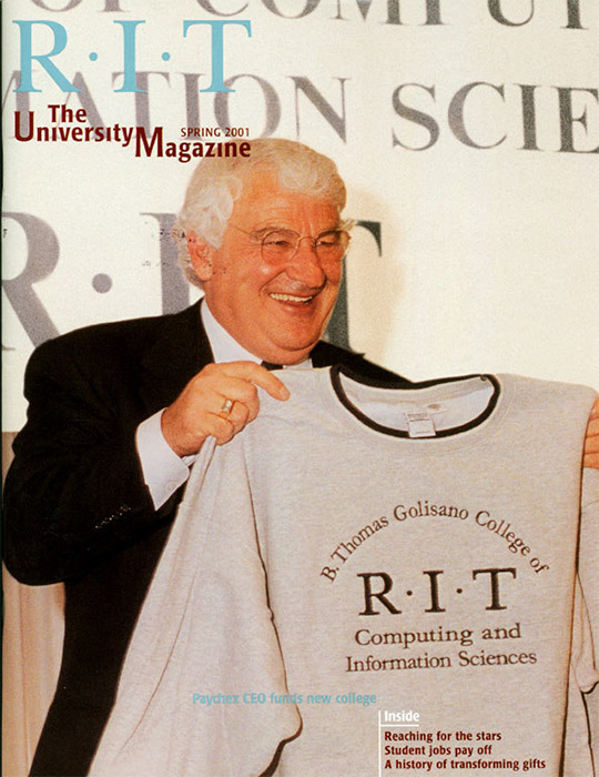 University Magazine cover featuring man holding up a T-shirt.