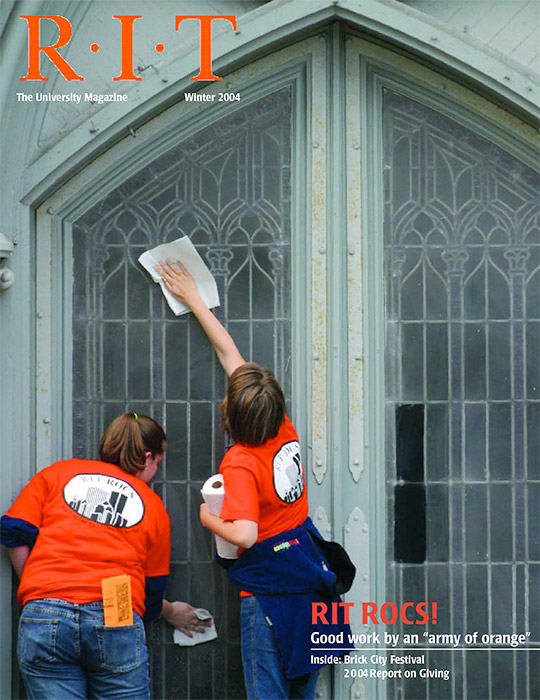 University Magazine cover featuring two people cleaning glass doors.