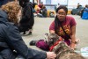 two students petting a bullmastiff dog.