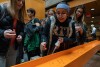 students signing an orange steel beam.