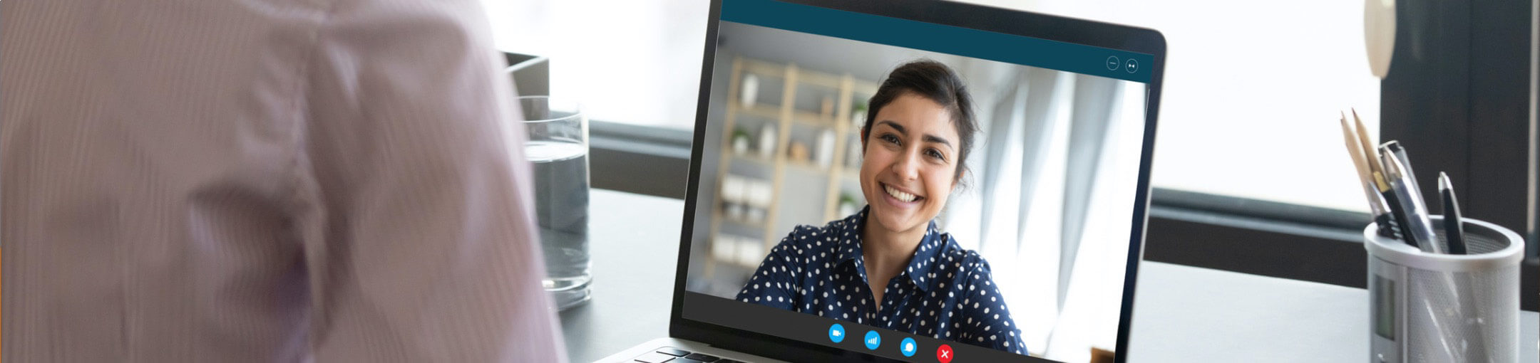 A person looking at a screen displaying the video feed of another person during a Skype video call.