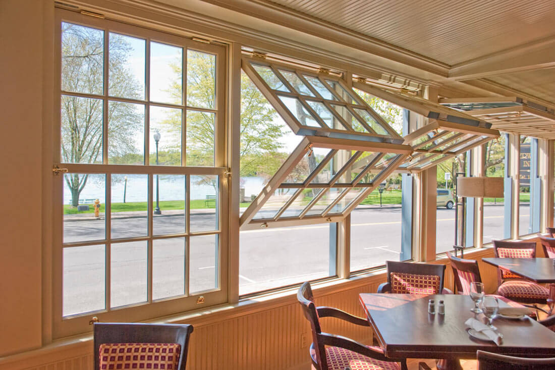 Interior of a restaurant dining room featuring folding windows from Rochester Colonial