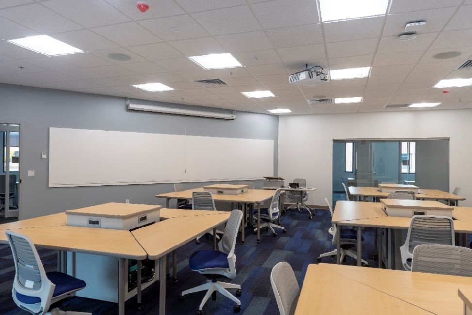 Open classroom with a large whiteboard on the opposite wall
