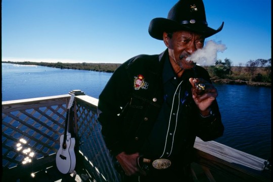 A portrait of Clarence Brown smoking a cigar.