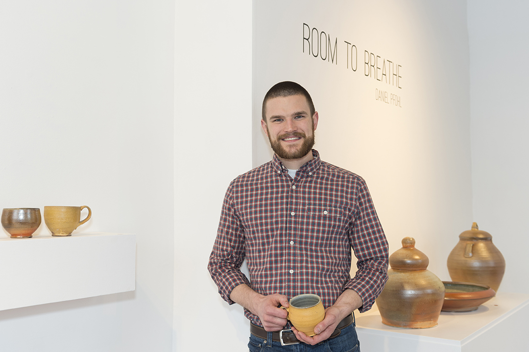 Dan Pfohl at the opening of his 2018 ceramics thesis exhibit at Flower City Arts Center.