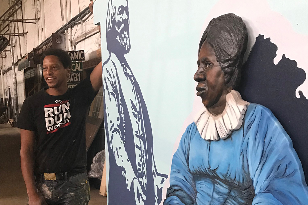 artist standing next to sculpture of Anna Murray Douglass, wife of Frederick Douglass.