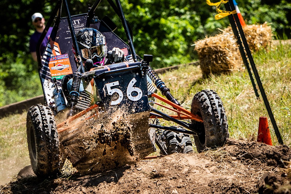 Baja car driving through mud.