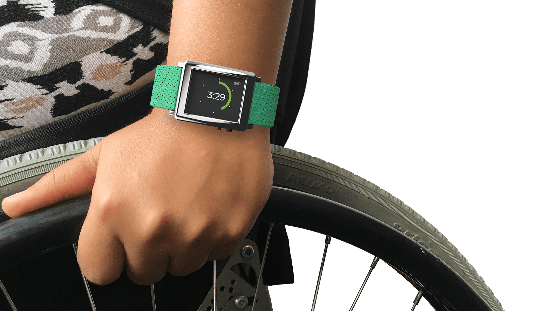 Close up photo of wrist with watch (time 3:29) grabbing on to the wheel of a wheelchair