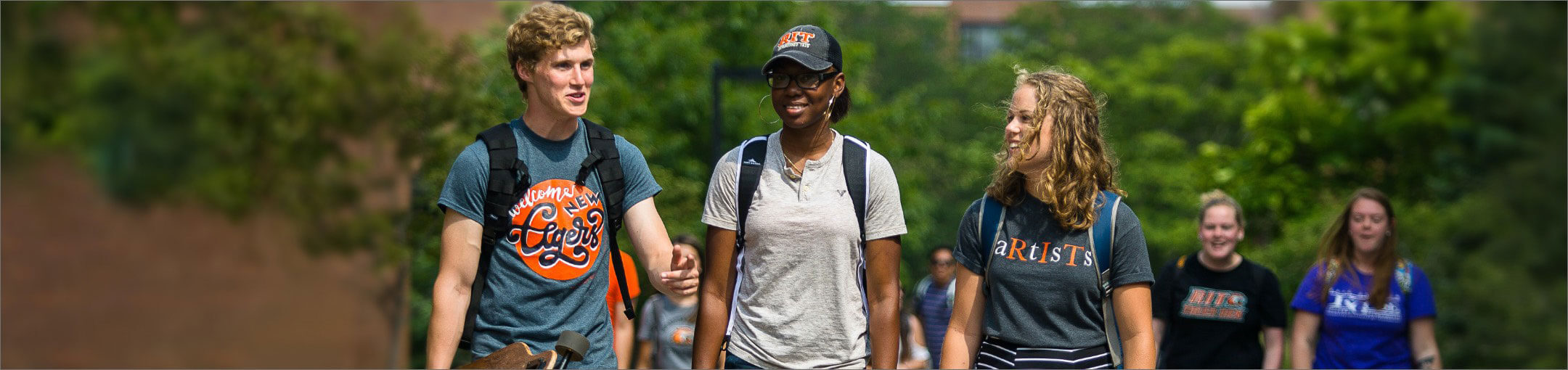 RIT students walking on the Quarter Mile walkway on campus.