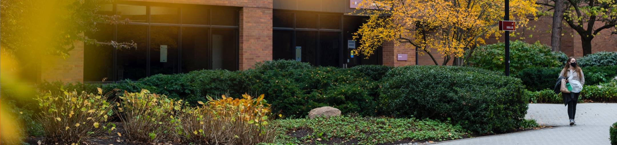 RIT campus with a singular student walking