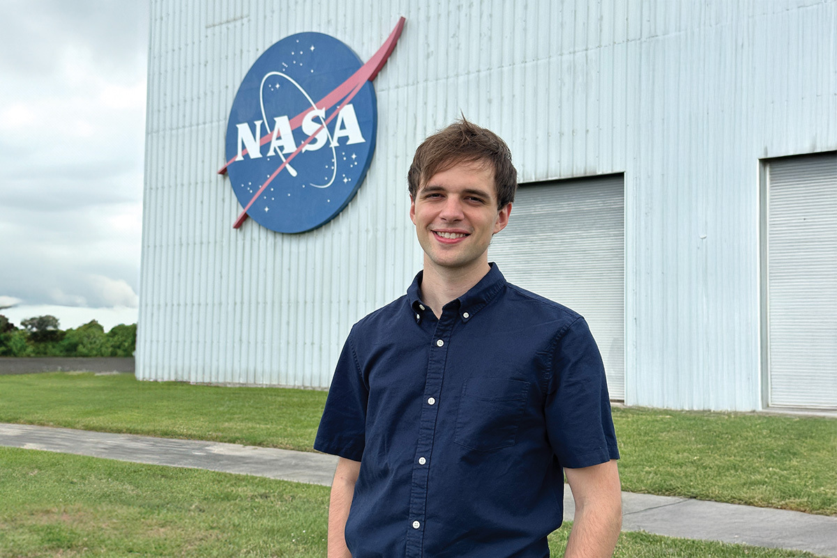 an RIT student stands in front of a NASA building