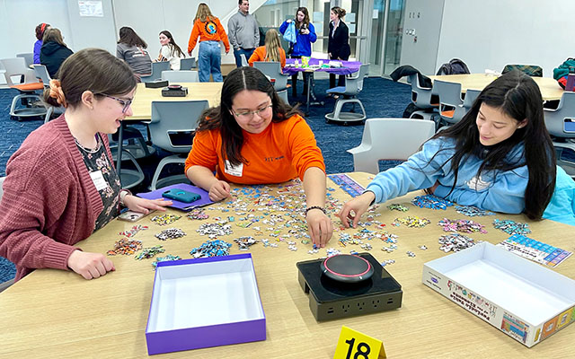 Students working on a jigsaw puzzle together