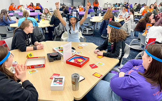 students with cards attached to their heads for the game heads up