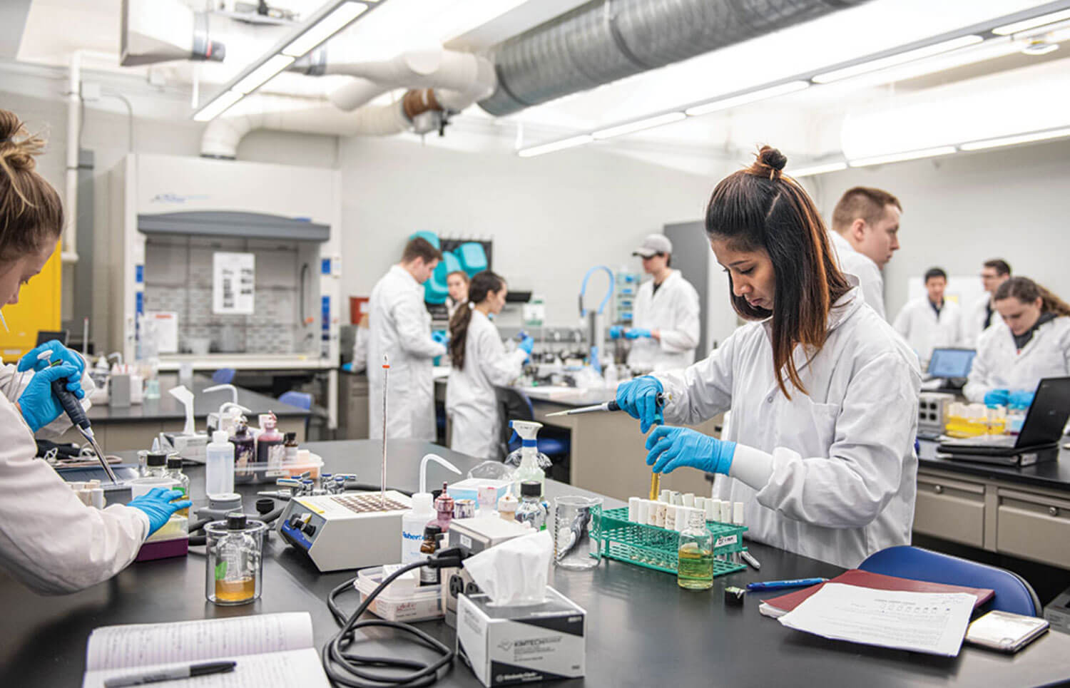 R I T students performing experiments in a lab.