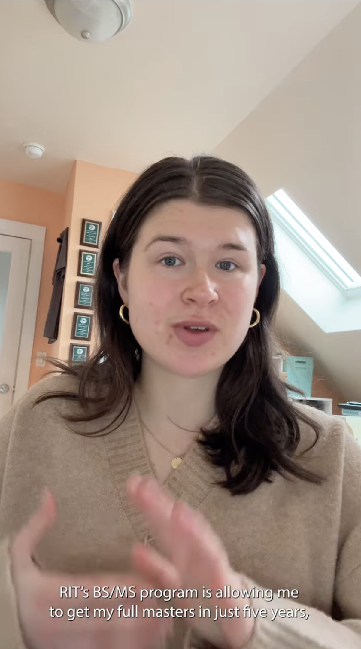 Student with brown hair and beige sweater