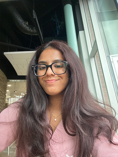 Selfie of a student in a pink shirt