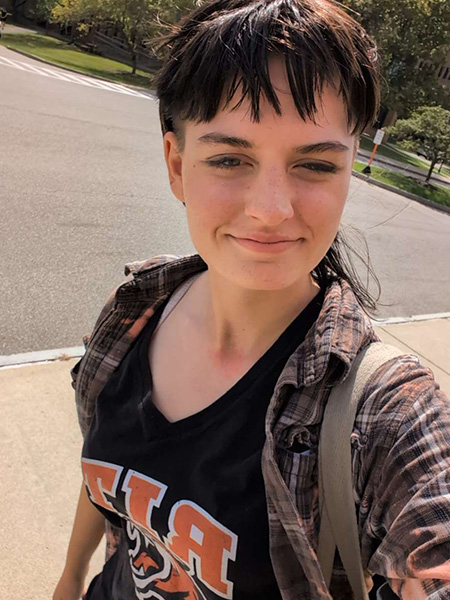 student in a black and plaid shirt