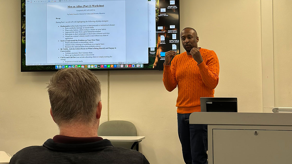 a male faculty member giving a presentation on men as allies.
