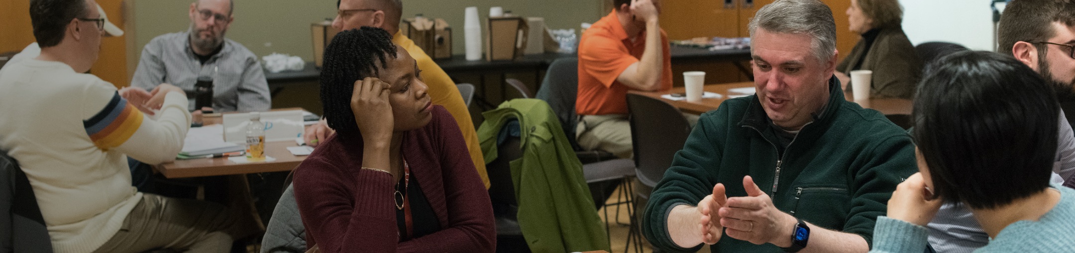 a diverse group of faculty members having a discussion.