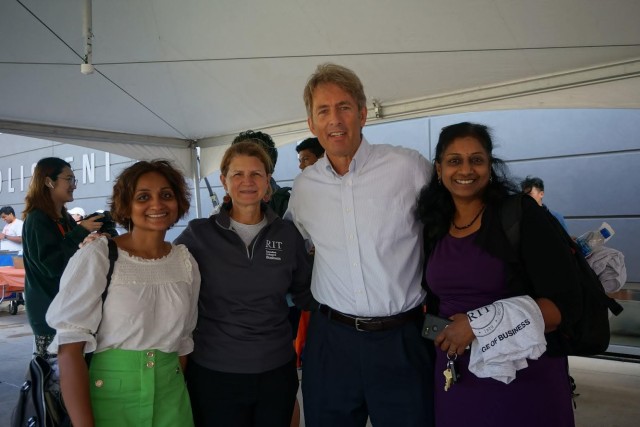 Faculty and staff smiling with Jacquie