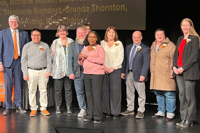 several people stand on a stage 