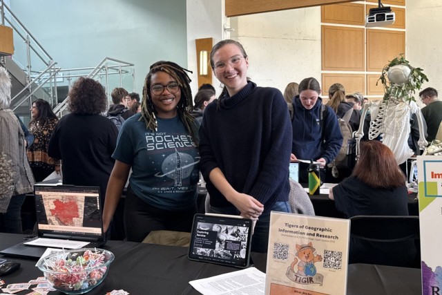 RIT students Destiny Patton, left, and Priscilla Anderson, right, spread the word about the Tigers of Geographic Information and Research (TIGIR) during a GIS immersion/minor fair. This new club looks to introduce students to the wide array of applications in the geospatial world. 
