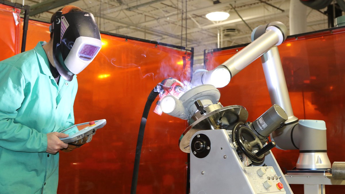 Kyle using the CMT welding cobot.