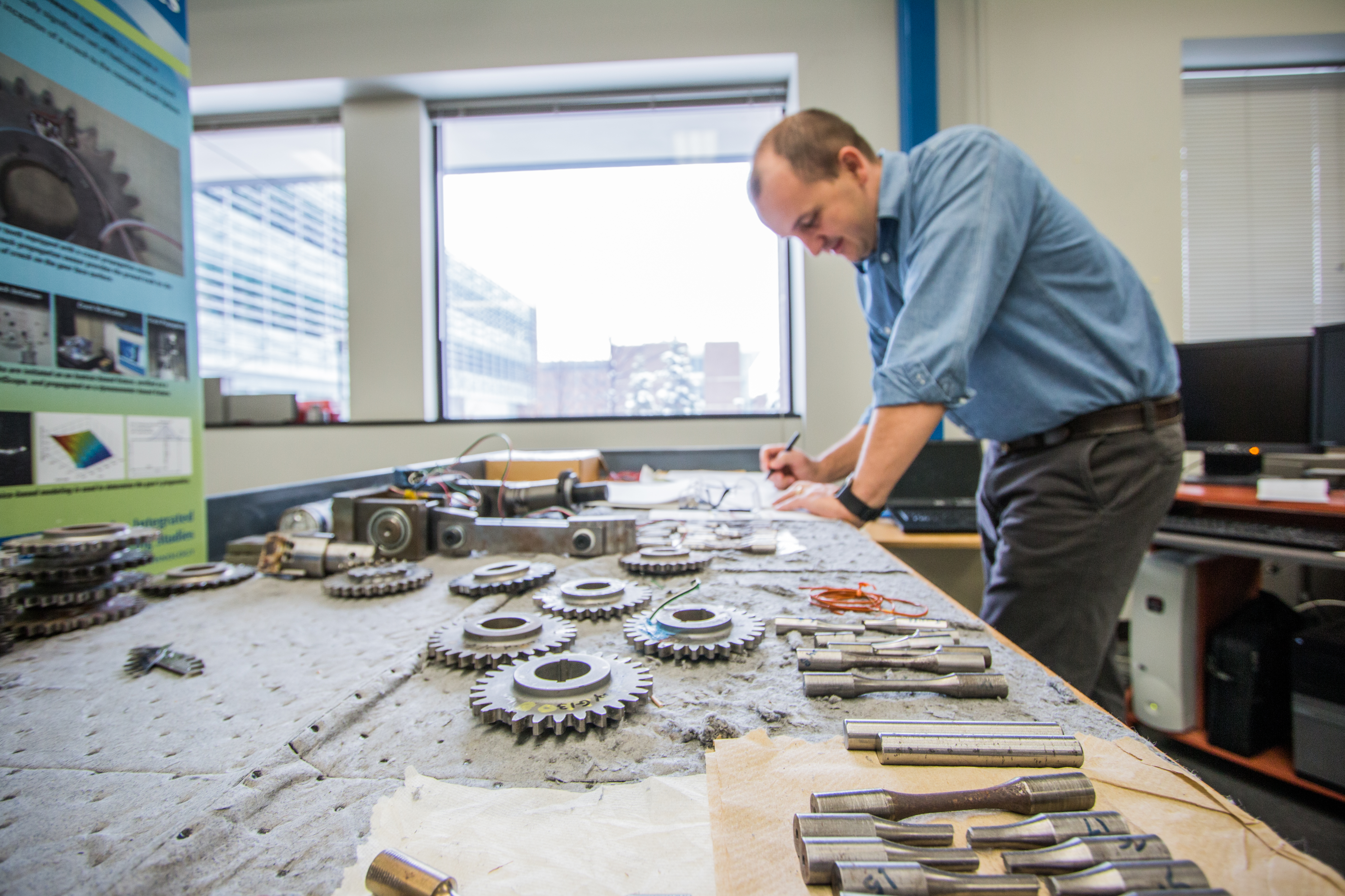 researcher working on different types of metal gears